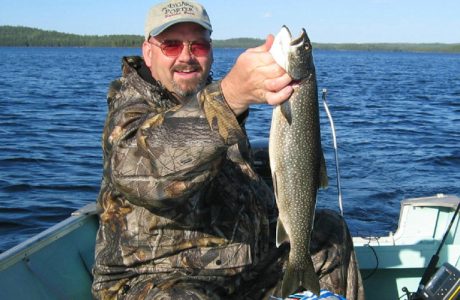 Happy Guest Holding Trout Fish